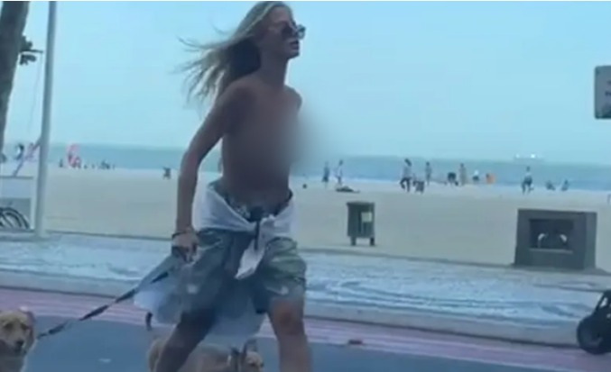 [VIDEO] Mulher é presa por caminhar na orla da praia de topless e é detida